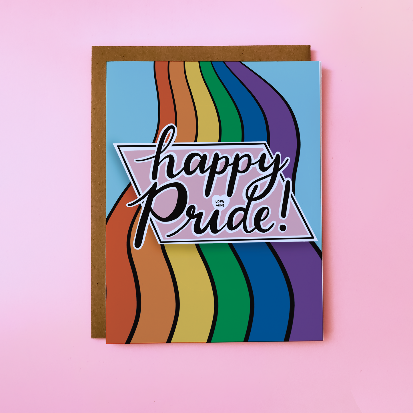 Colorful Happy Pride card featuring a wavy rainbow on the front. 'Happy Pride' is positioned over the rainbow, and the 'i' in pride is a heart reading "Love Wins"
