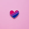 Bisexual Pride Heart Pin on a pink background. Pin is has vibrant bisexual pride colours set in a polished nickle metal. Bisexual pride pin colours are pink, purple and blue.Bi Heart Pin - LGBTQ Pride Pins | Little Rainbow Paper Co