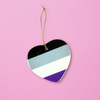 Ceramic heart shaped LGBTQ ornament with the ace pride colors on a pink background. Heart Ace pride ornament
