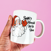 hand holding LGBTQ mug that reads Santa's Favourite Homo. A gay christmas mug